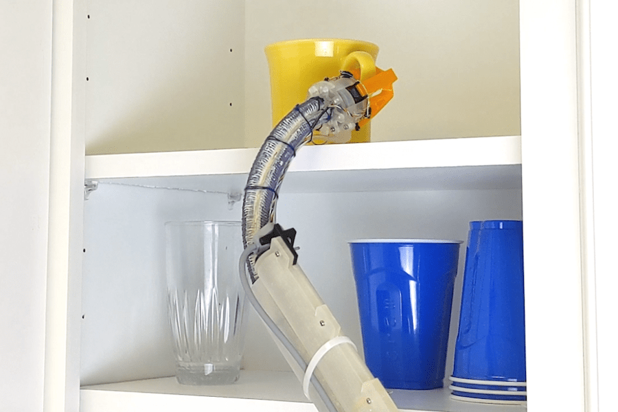 A robotic arm reaching for a mug