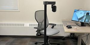 The Stretch RE1 robot next to an office chair and desk